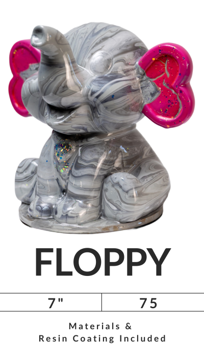 Gray elephant figurine with pink glitter ears on display with the word 'FLOPPY' and size details.