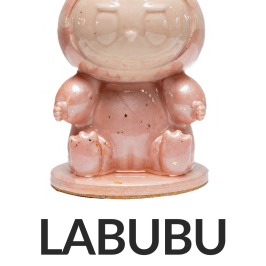 Pink rabbit-like figurine with 'LABUBU' and '7