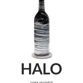 A table lamp with a black bottle base and white shade, labeled 'HALO' 15 inches tall.