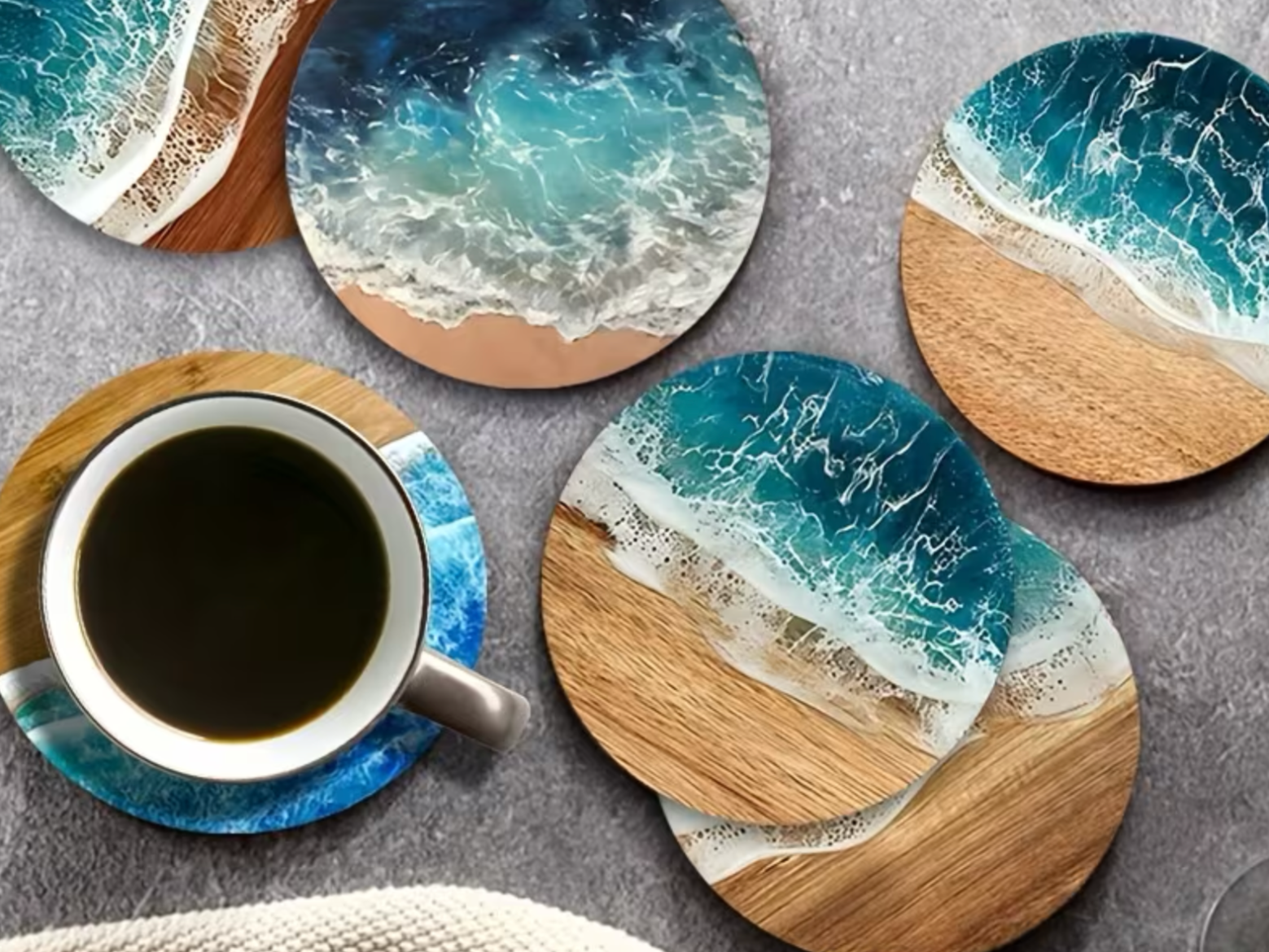 Round coasters with ocean wave designs and a cup of coffee on one of them.